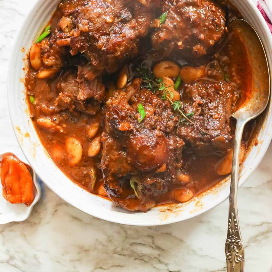 Delicious Southern oxtail stew garnished with fresh herbs